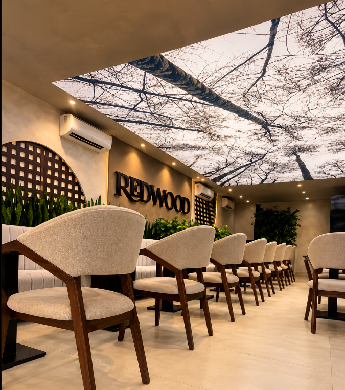REDWOOD dining room with the REDWOOD sign and tree canopy ceiling