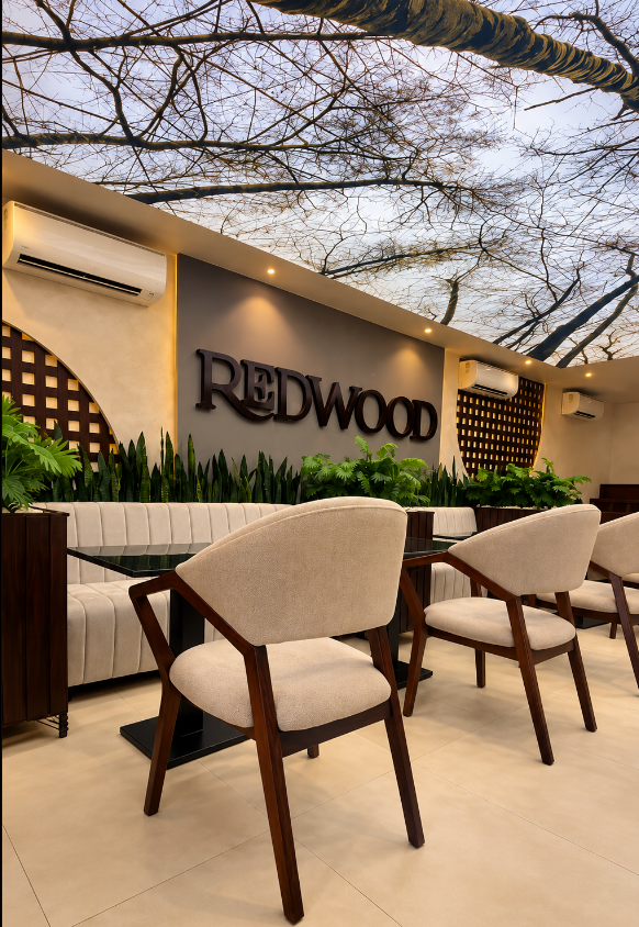 Upholstered chairs before the REDWOOD sign