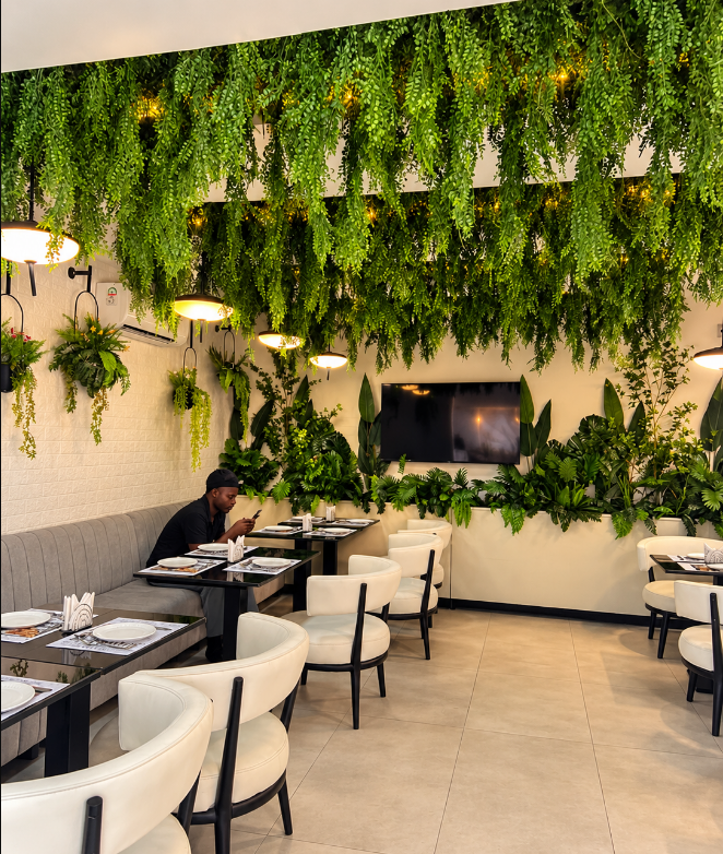 REDWOOD dining room beneath a canopy of hanging plants
